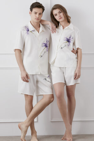 A man and woman in Lrisette Unisex Floral Silk Shirts posing elegantly.