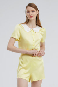 Young woman in a Yellow Doll Short Loungewear Set with a white Peter Pan collar, standing against a light background.