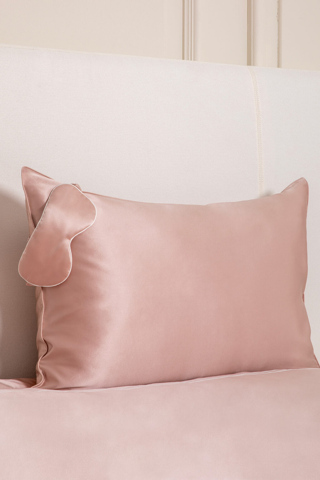 HA Silk Pillowcase & Eye Mask Gift Box in blush pink, featuring a silk pillowcase and matching eye mask on a bed.