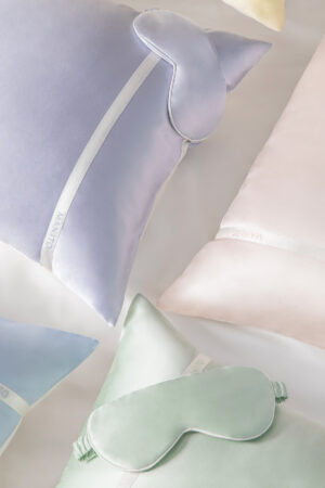 Macaron Silk Pillowcase & Eye Mask Set in assorted pastel colors displayed together for a soft, elegant travel-ready look.