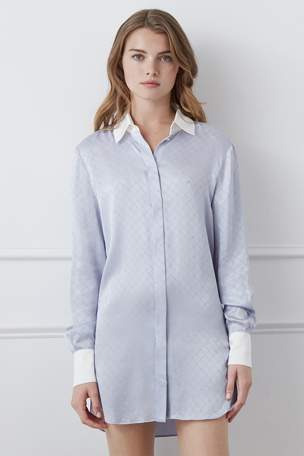 A woman presents the Monogram Silk Long Shirt with a delicate geometric pattern and contrasting white collar.