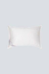Premium silk filled pillow with 'MANITO' tag, offering a soft and luxurious addition to bedroom comfort.