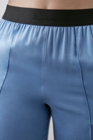 Close-up of blue Vibrant Silk Pants waist and hip area highlighting smooth silk fabric.