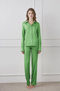 Vibrant Silk Shirt in green displayed on model, featuring a simple and sleek silhouette.