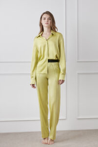 Model wearing the Vibrant Silk Shirt in yellow green, showing a relaxed and elegant style.