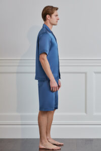 Side view of model wearing MANITO Sketchy Men's Silk Pajama Set in blue.