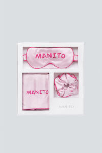 Elegantly packaged MANITO macaron silk eye mask gift box displayed, ideal for a luxurious gift, includes eye mask, scrunchie, and pillowcase.