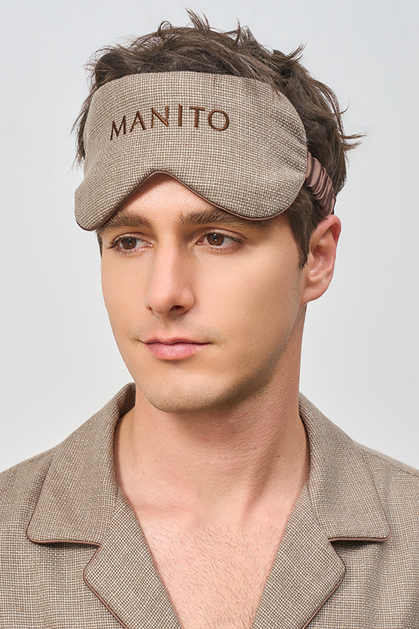 Man wears Maple Men's Eye Mask in soft brown silk cashmere, creating a calm, restful bedtime mood.