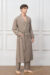 Model wearing the Maple Men's Long Robe, showcasing the earthy brown tone, textured check weave, and relaxed shawl-collar silhouette.