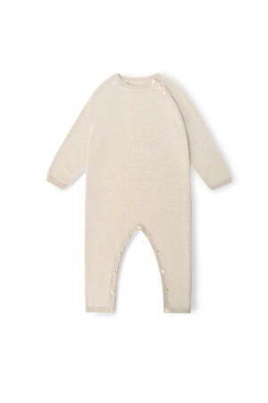 Mellow Baby's long-sleeve knit onesie in sand-camel, showing snap buttons along the legs for easy diaper changes.