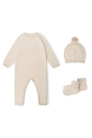 Flat lay of Mellow Baby's Knit Onesie Set in sand-camel, with long-sleeve onesie, pompom hat, and socks arranged neatly.