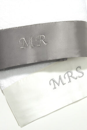 Mr. & Mrs. Bath Towel set with embroidered MR and MRS details on silk trim, showcasing fine craftsmanship and elegant design.