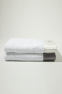 Mr. & Mrs. Bath Towel set stacked with white and gray silk trims, made from Xinjiang long-staple cotton for a soft, fluffy touch.