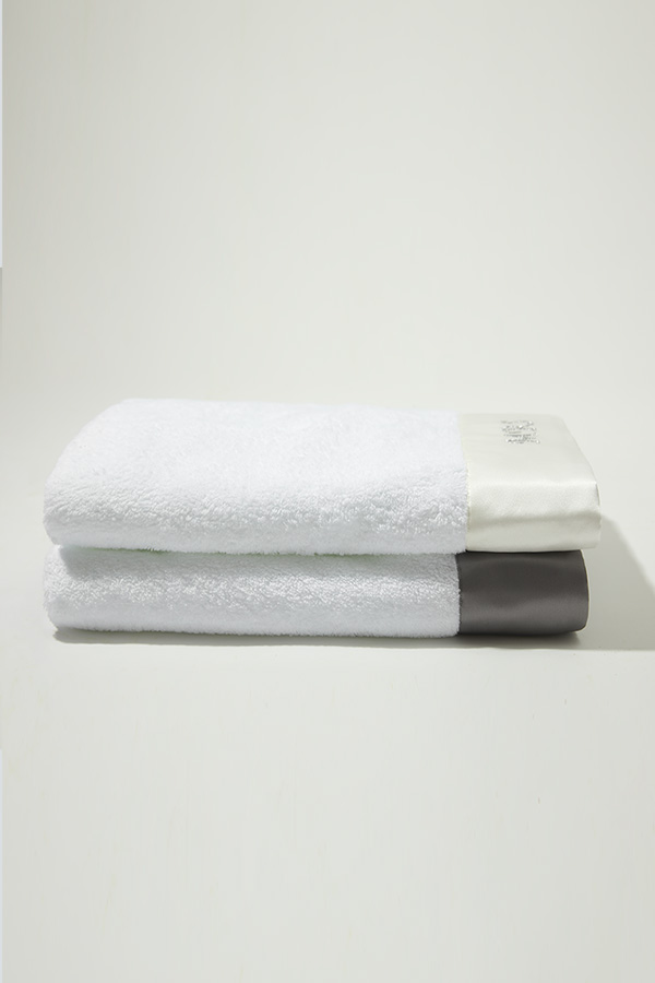 Mr. & Mrs. Bath Towel set stacked with white and gray silk trims, made from Xinjiang long-staple cotton for a soft, fluffy touch.