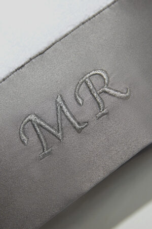 Mr. & Mrs. Bath Towel close-up of MR embroidery on gray silk trim, highlighting smooth texture and premium stitching.