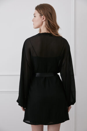 Woman in a black Latica Lace-trimmed Silk Robe featuring lace trim and a satin tie, back view highlighting the elegant flow.