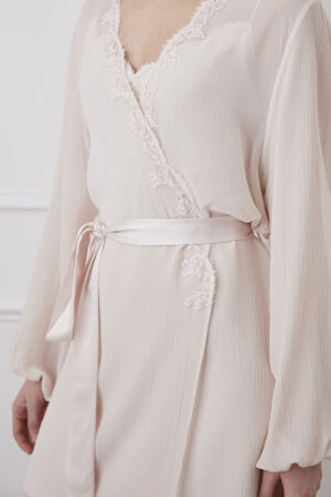 Close-up of the lace trim detailing on a pink Latica Silk Robe with satin sash.