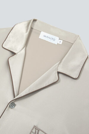 Close-up of MANITO Neat Men's Lounge Set in taupe with contrasting piping on collar.
