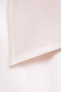 Detail shot of the polo shirt collar tip from MANITO new authentic women's polo shirt pajama set in a ballet pink color.
