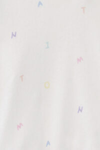 Pattern close-up of New Signature Children's Knit Pajama Set, with rainbow letters scattered across for a cheerful look.