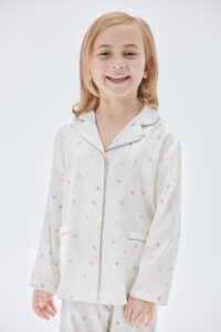 Model wears New Signature Kid's Pajama Set with colorful letter prints and mulberry silk fabric.