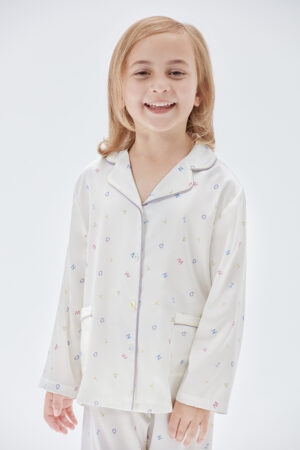 Model wears New Signature Kid's Pajama Set with colorful letter prints and mulberry silk fabric.