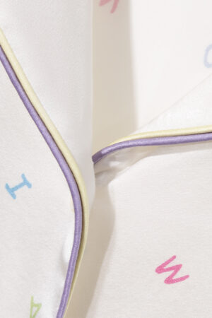Close-up of New Signature Kid's Pajama Set collar with fine silk piping and multicolor details.