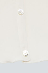 Close-up of the button on New Soft white camisole set, highlighting the premium detailing and MANITO's brand logo.