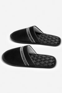 Pair of NoirRuban Men's Silk Lounge Shoes laid flat with ribbon-trimmed vamp and diamond-quilted insoles.