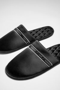 Close view of NoirRuban Men's Silk Lounge Shoes, highlighting the smooth satin texture and MANITO logo ribbon across the vamp.