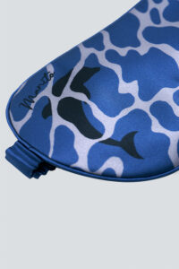 Detail shot of dolphin print on MANITO Ocean Blue Dolphin Silk Eye Mask's ocean camo design.
