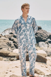 A model standing by the seaside in MANITO Ocean Blue Men's Pajama Set.