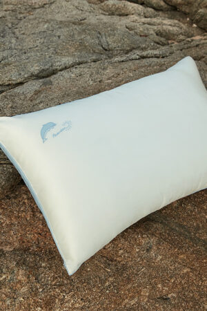 Silk pillowcase from MANITO Ocean Blue Sleeping Beauty Gift Box placed on natural stone.