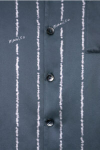 Detail shot of MANITO Ocean Stripe Men's Pajama Set front buttons and subtle stripe-textured fabric showcasing elegant design.