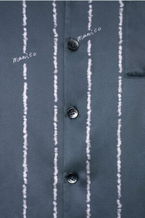 Detail shot of MANITO Ocean Stripe Men's Pajama Set front buttons and subtle stripe-textured fabric showcasing elegant design.