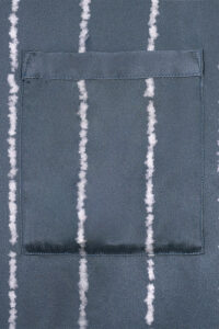 Pocket stitching detail on MANITO Ocean Stripe Men's Pajama Set with crisp vertical lines and smooth mulberry silk finish.