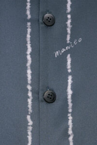 Detail of buttons and MANITO embroidery on MANITO Ocean Stripe Men's Short Pajama Set.
