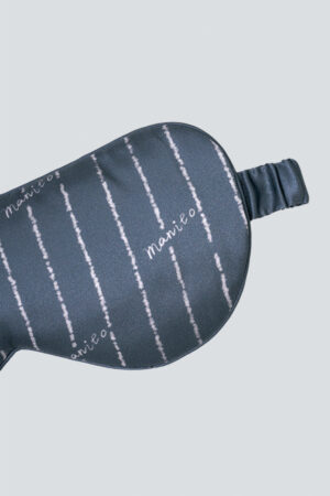 Close-up of vertical stripe detail and MANITO logo on Ocean Stripe Men's Silk Eye Mask.
