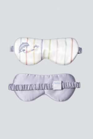 MANITO silk eye mask featuring a vibrant striped print on one side and smooth lavender silk on the other.