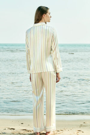 Back view of a model wearing a MANITO rainbow striped long sleeve shirt and pants.