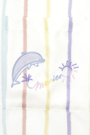 Detailed embroidery of a dolphin and sun on MANITO rainbow striped shirt pocket.