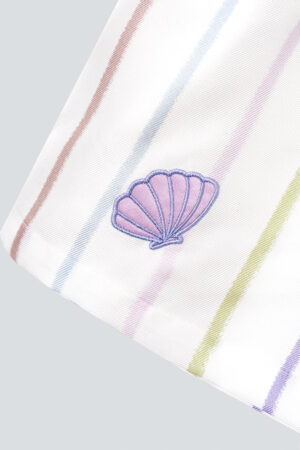 A close-up of the scallop shell embroidery on MANITO rainbow striped shirt sleeve.