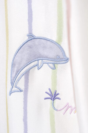 Close-up of the dolphin embroidery on MANITO Ocean Stripe Silk Short Robe.
