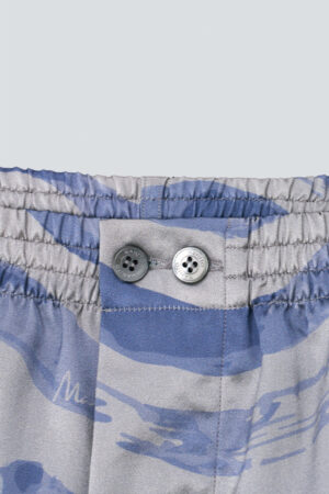 Close-up of the waistband and button detail on MANITO Ocean Wave Men's Shorts.