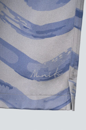 Embroidered MANITO logo on the hem of Ocean Wave Men's Shorts with signature wave design.