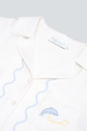 Close-up of collar and dolphin-embroidered pocket on the MANITO Ocean Wave Silk Women's Short Pajama Set.