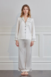 Straight front view of ivory MANITO Treasure Silk Pajama Set with contrast trim and loose fit.
