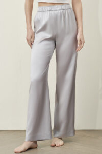 Model wearing MANITO Passion Women's Silk Trousers in silver gray, featuring a relaxed fit and elastic waistband.