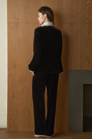 Back view of woman wearing Poetic Tulle Collar Velvet Pajama Set, showing the smooth fall of the black velvet sets.