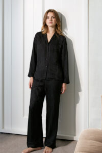 Model displaying Faery Women's Pajama Set in elegant black silk for a timeless and sophisticated look.
